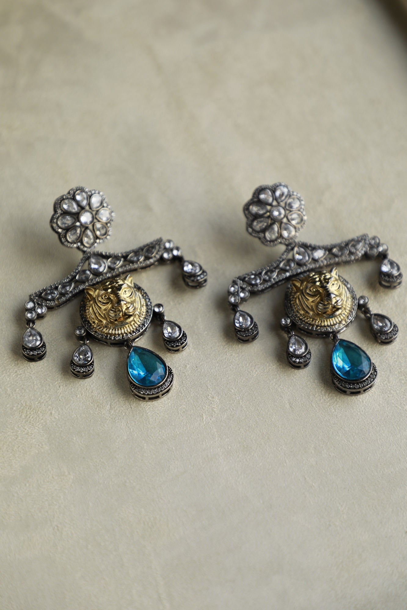 Golden Lion Faced Earrings With Crystal Blue Tear Drop