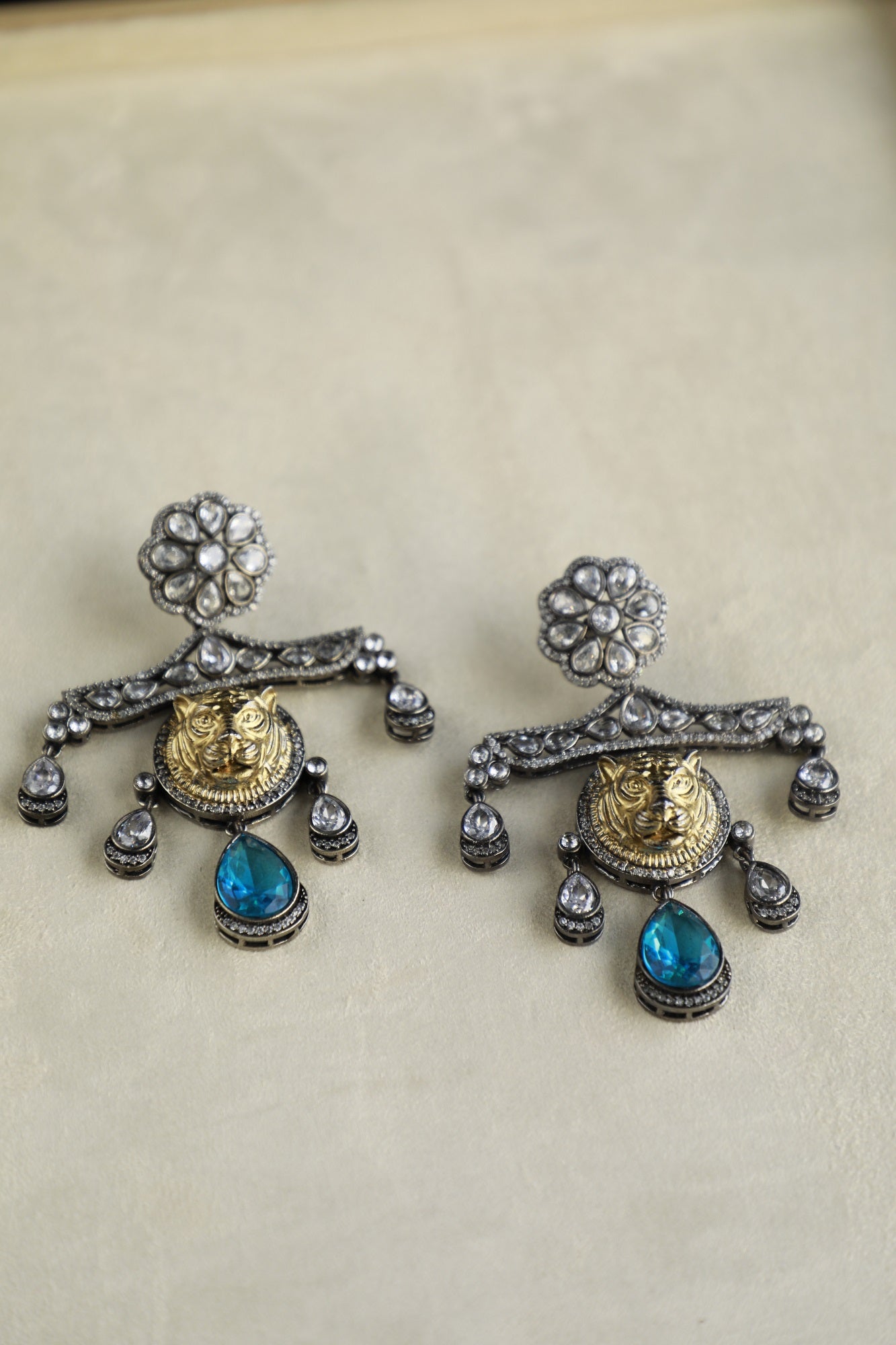Golden Lion Faced Earrings With Crystal Blue Tear Drop